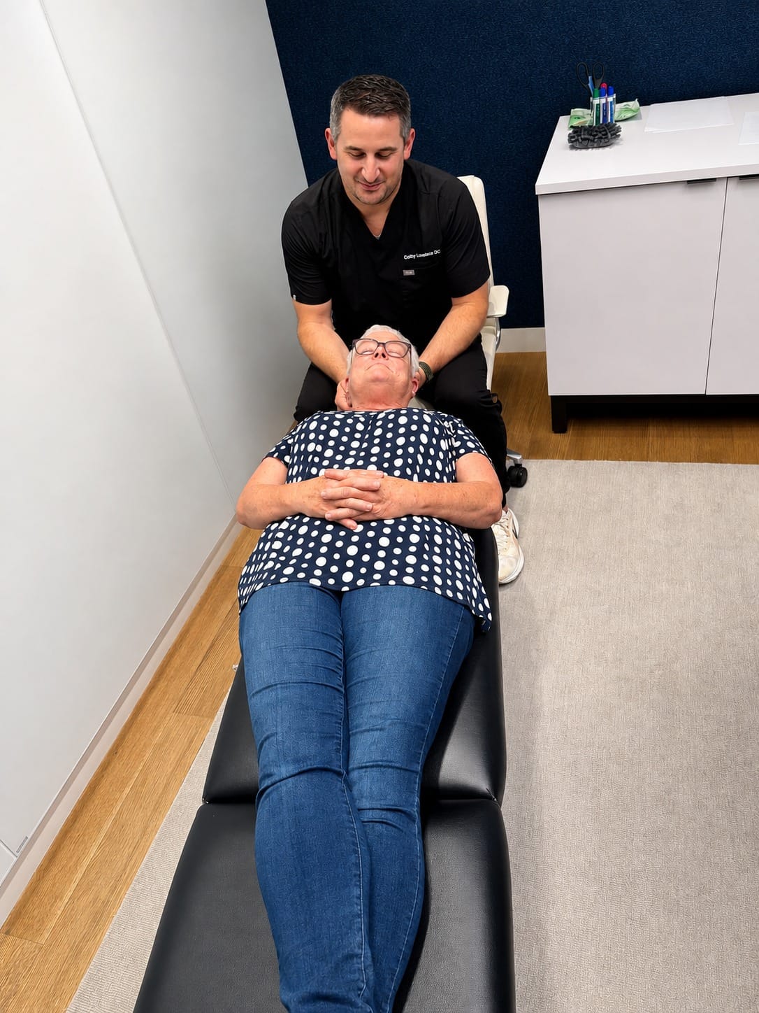 Dr. Lovelace performing a one-on-one chiropractic adjustment during an on-site corporate wellness visit